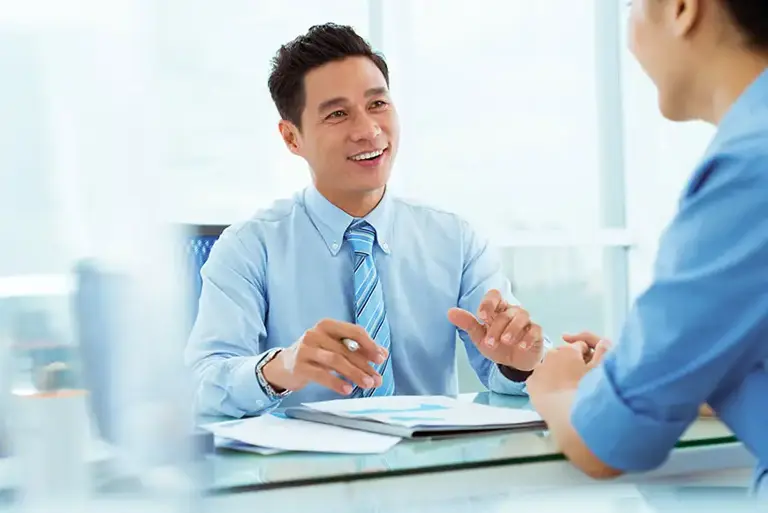 Two men in an office setting are in conversation